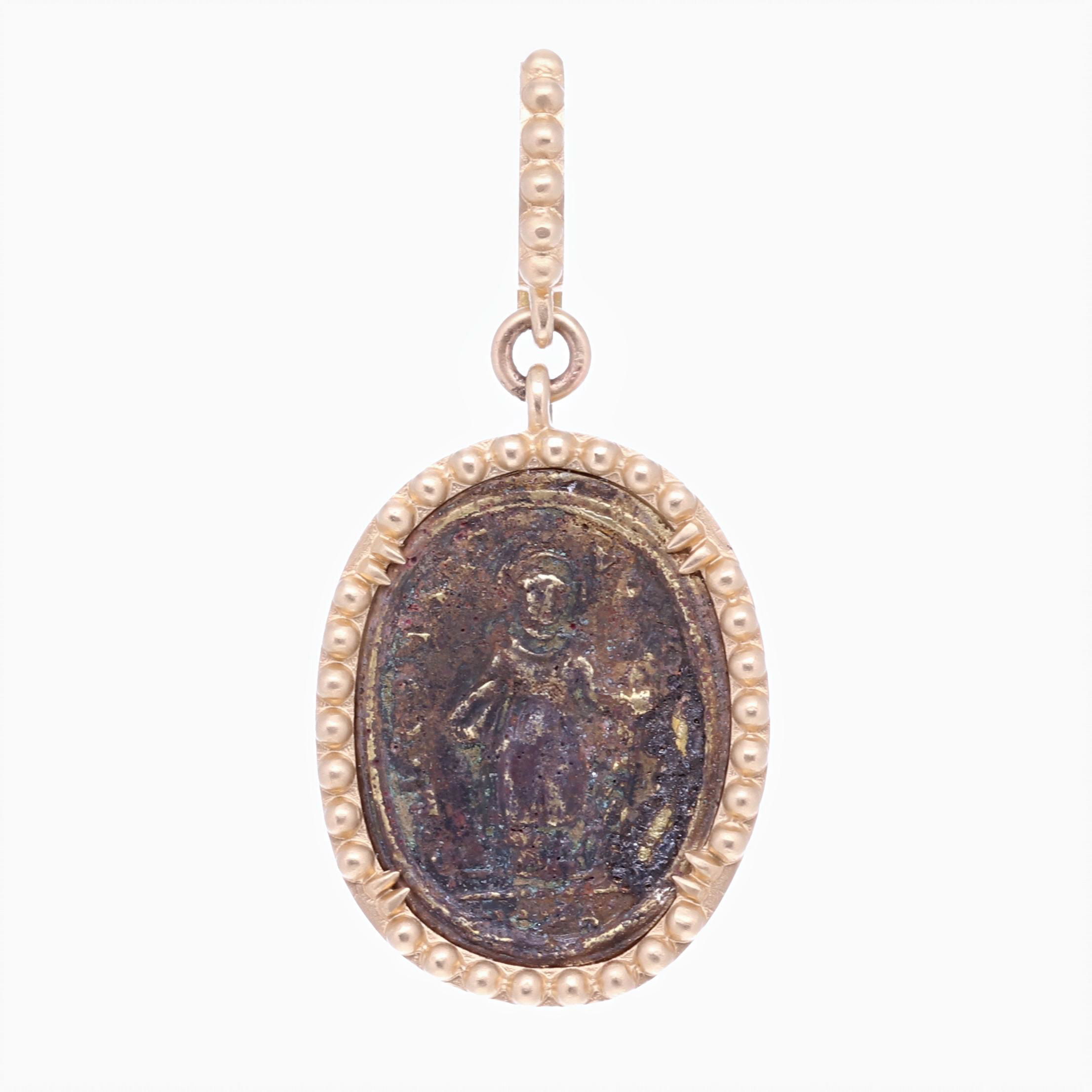 St. Michael, the Archangel, also known as “The Angel of the Lord”. He's the leader of the war against Satan and is usually depicted with a sword slaying an evil dragon. The sword is double edged, representing truth and justice. Known as the Archangel of battle and defender of heaven, St. Michael is said to be the patron saint of police, mariners, and sickness. He is also known at the “Protector of the Church”. This antique St. Michael medal has been set inside a solid 14k Yellow 7.5g bezel. The bale has a 4mm opening. 17th C. St. Michael Pendant