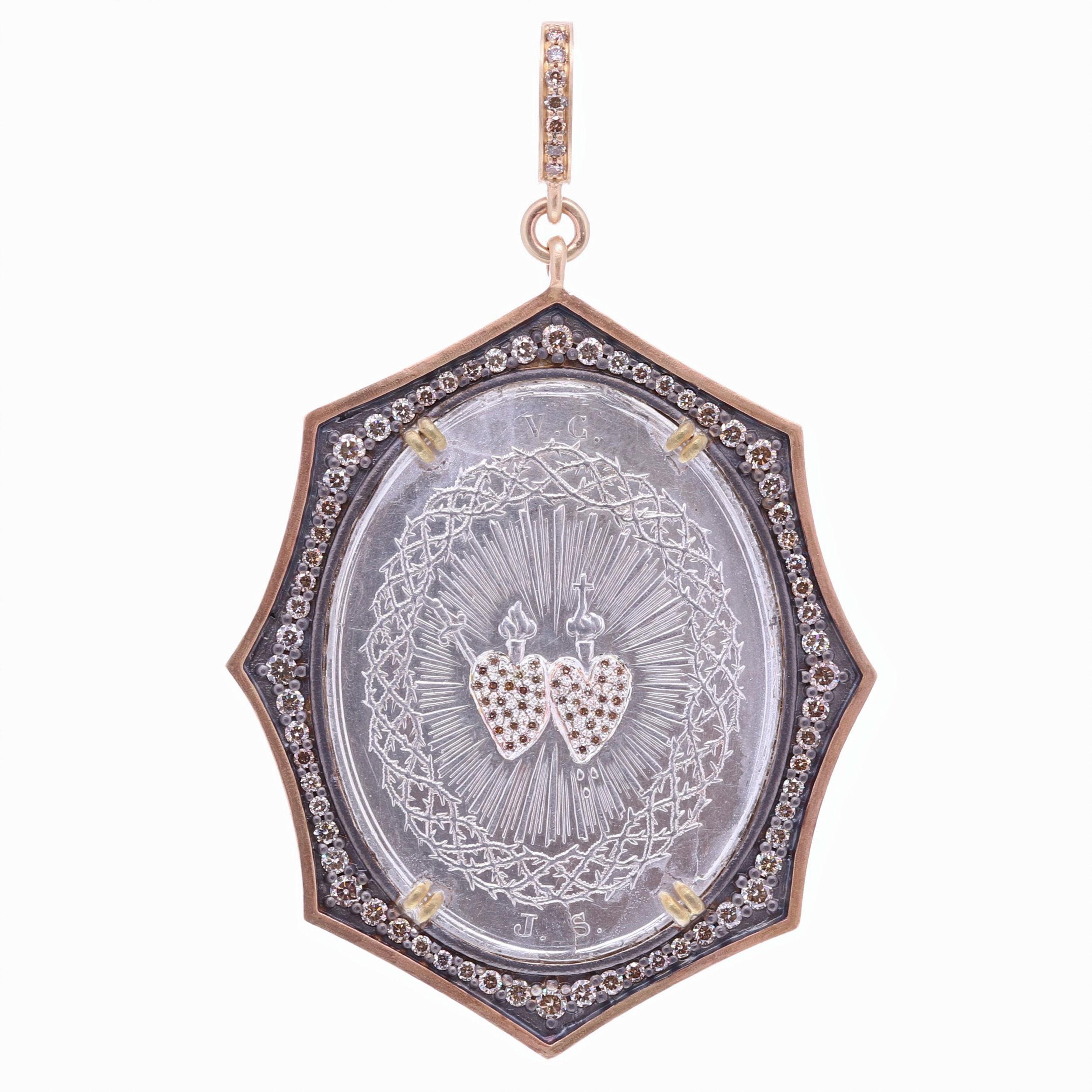 This French Sacred & Immaculate Heart medal has the letters V.C and J.S engraved on the front. The original medal was handcrafted by a master silversmith, displaying his technique for intricate filigree. The front proudly displays a pair of hearts: Jesus's Sacred Heart and Mary's Immaculate Heart. Jesus's Heart displays his infinite love for all of humanity. Mary's Immaculate Heart represents her maternal love. The back of the medal has a beautiful Miraculous Mary and translates to "Mary Conceived without sin, pray for us". This original French medal is set in a Cynthia Ann 14k yellow gold 6.1g, champagne diamond 1.30 tcw, and rhodium sterling bezel. French Sacred & Immaculate Heart Pendant