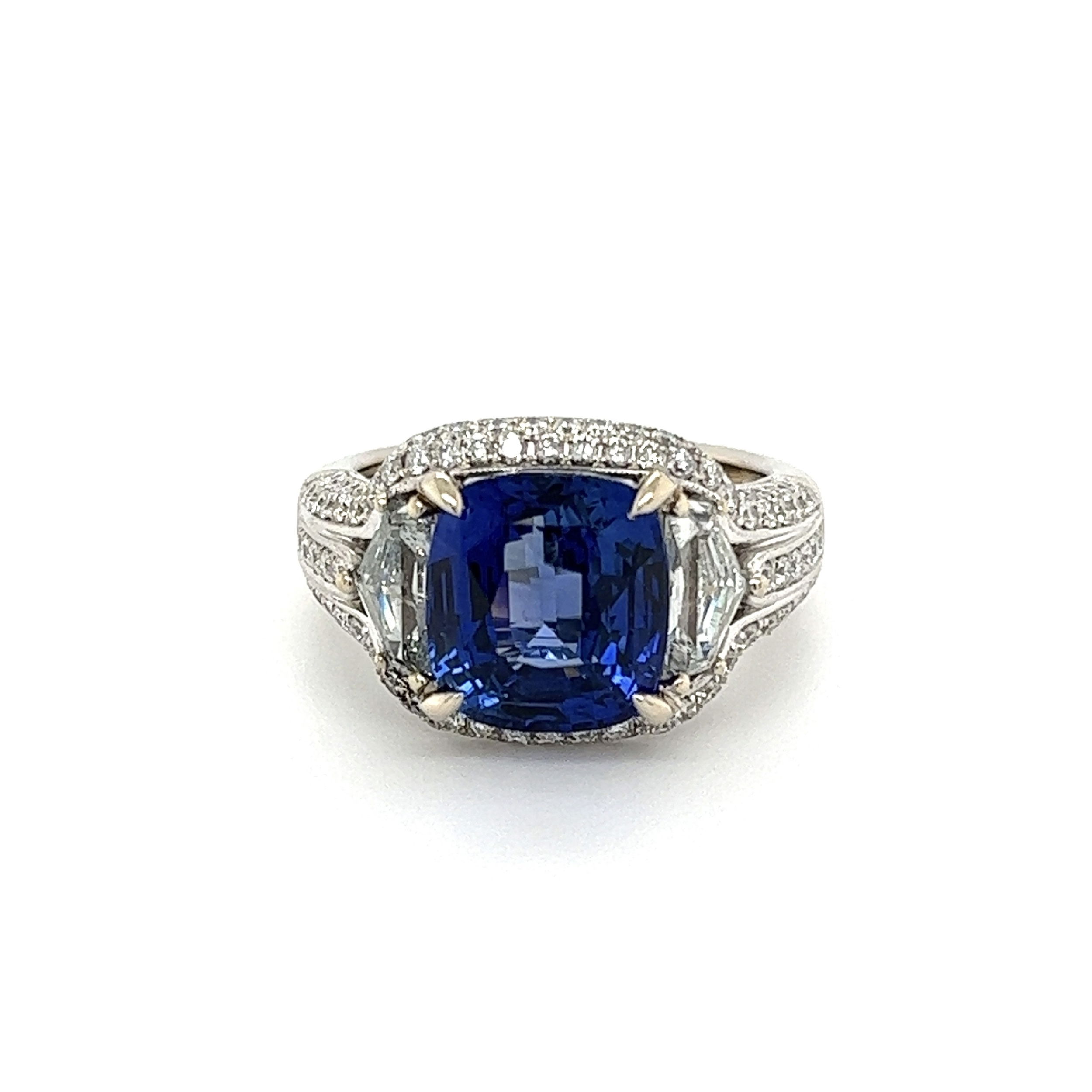 This exquisite Platinum 6.03ct Gorgeous Cushion Sapphire GIA & 1.35tcw Diamond Ring is a stunning statement piece. The gleaming platinum band is encrusted with brilliant diamonds, drawing the eye to the gorgeous center cushion cut sapphire. The majestic gemstone is certified by the Gemological Institute of America (GIA), giving you peace of mind in its authenticity and quality. With a combined weight of 8.5g and a size 6.5, this dazzling ring will be the perfect addition to any jewelry collection.GIA# 22310558642 shield cut diamonds are approx. .85tcw & RBC diamonds are approx. .50tcw Platinum 6.03ct Gorgeous Cushion Sapphire GIA & 1.35tcw Diamond Ring 8.5g, s6.5