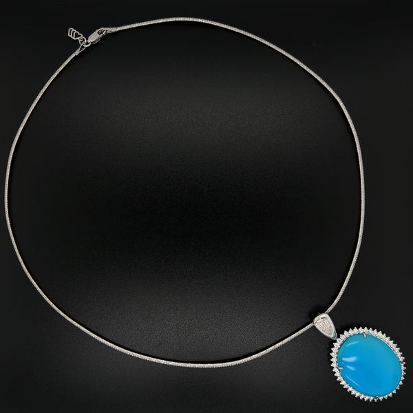 Closeup photo of 18K WG 28ct Oval Turquoise & .85tcw Diamond Halo Pendant 17.3g, on 2tone Stiff Choker 16.5"