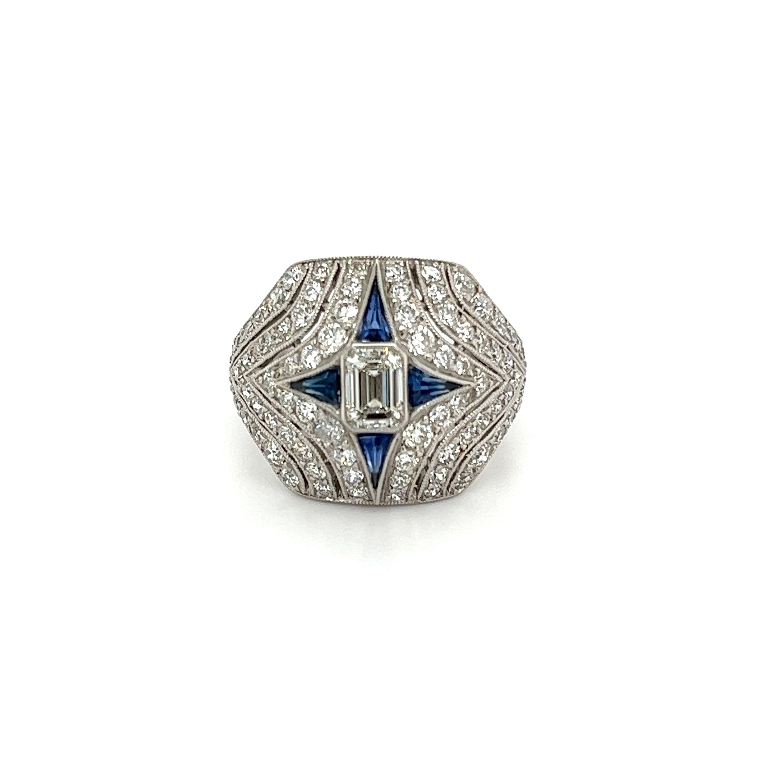 This stunning estate platinum ring features a beautiful emerald cut diamond weighing .50cts with 1.50tcw of OEC diamonds and .20tcw of calibrated sapphires. Crafted with glittering diamonds and sapphires, this eye-catching design is sure to make a memorable statement that will turn heads. The ring weighs 7.8 grams and has a finger size of 6.75. With its unique combination of precious metals and stones, this ring is a luxurious addition to any jewelry box. Platinum .50ct Emerald Cut, 1.50tcw OEC Diamonds & .20tcw Calibrated Sapphire Ring 7.8g, s6.75