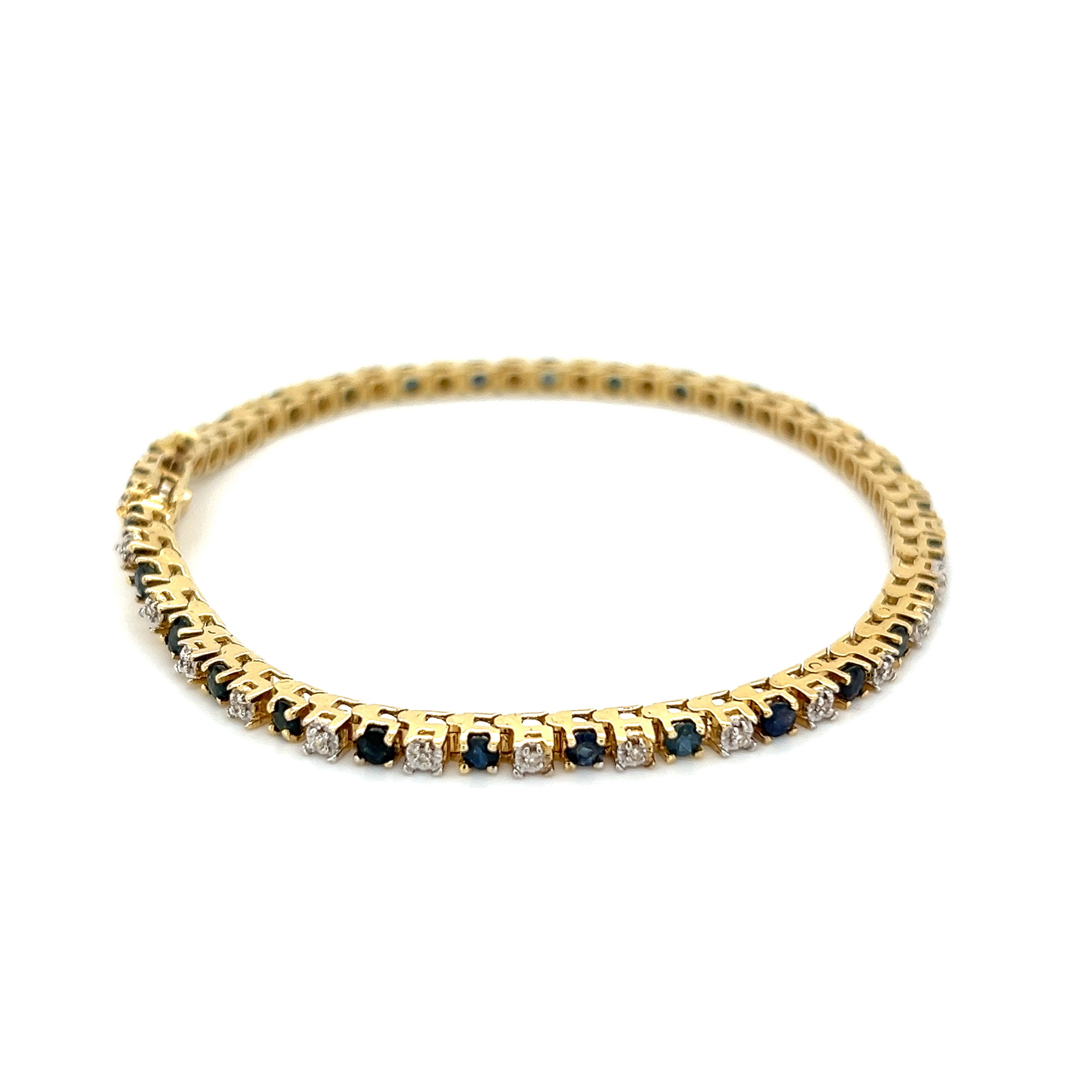 This luxurious 14K YG Alternating 1.50tcw Sapphire & .12tcw Diamond Line Bracelet is the perfect gift for any occasion. Crafted with yellow gold, the bracelet features alternating sapphires and diamonds for a dazzling effect. The total carat weight is 1.50tcw for the sapphires and .12tcw for the diamonds. This striking bracelet weighs 8.5g and measures 6.85”. Show off the elegance of this bracelet for a special occasion or simply add sparkle to your everyday look. 14K YG Alternating 1.50tcw Sapphire & .12tcw Diamond Line Bracelet 8.5g, 6.85"