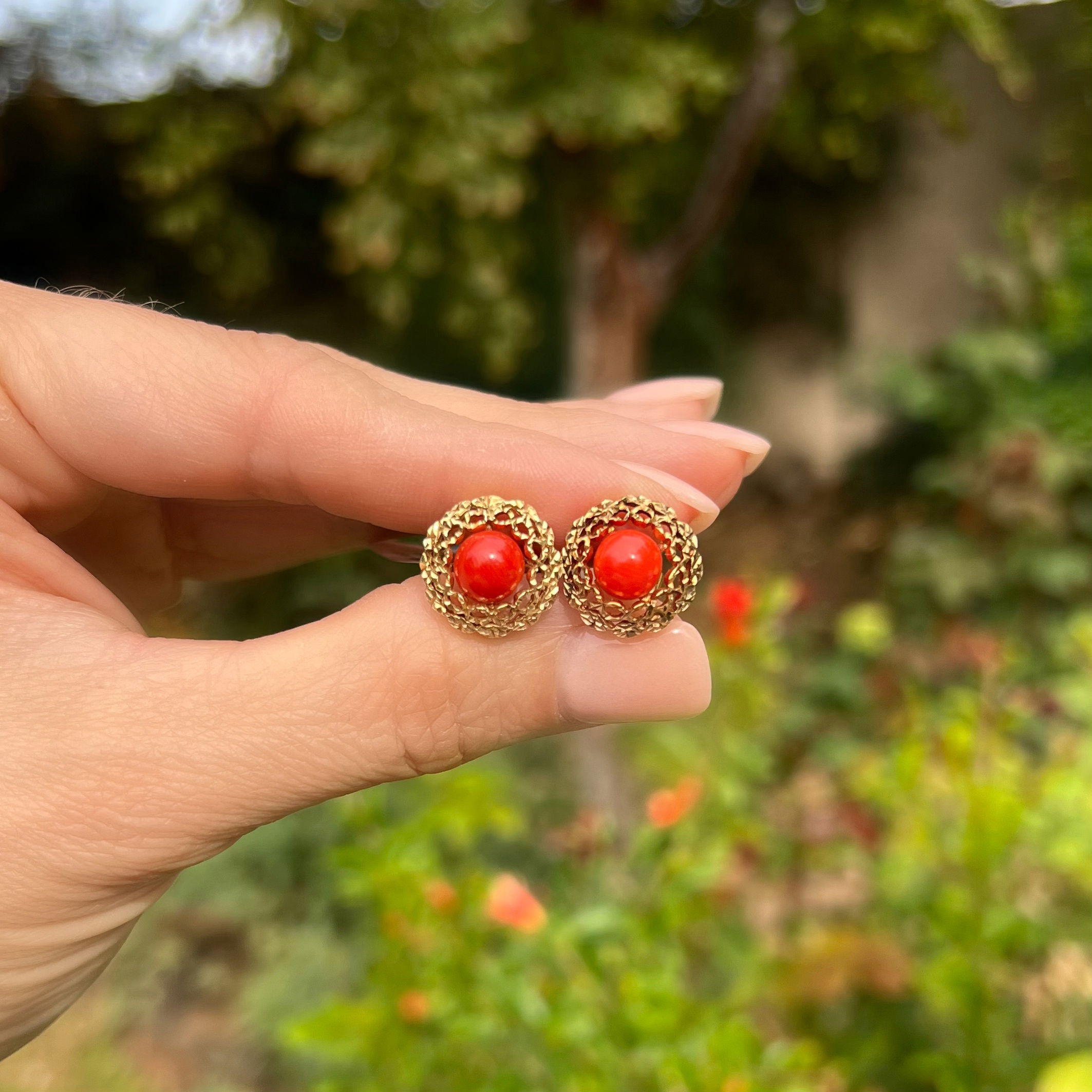These classic 14K yellow gold estate earrings from the 1960s are sure to make a statement. The circular fluted studs feature an impressive 1.60 tcw of beautiful coral for an elegant touch. At 4.8 g, these earrings offer a great look with premium quality. The perfect piece for any occasion, these earrings are sure to become a timeless addition to any jewelry collection. 14K YG 1960's Coral 1.60tcw Circular Fluted Stud Earrings 4.8g,