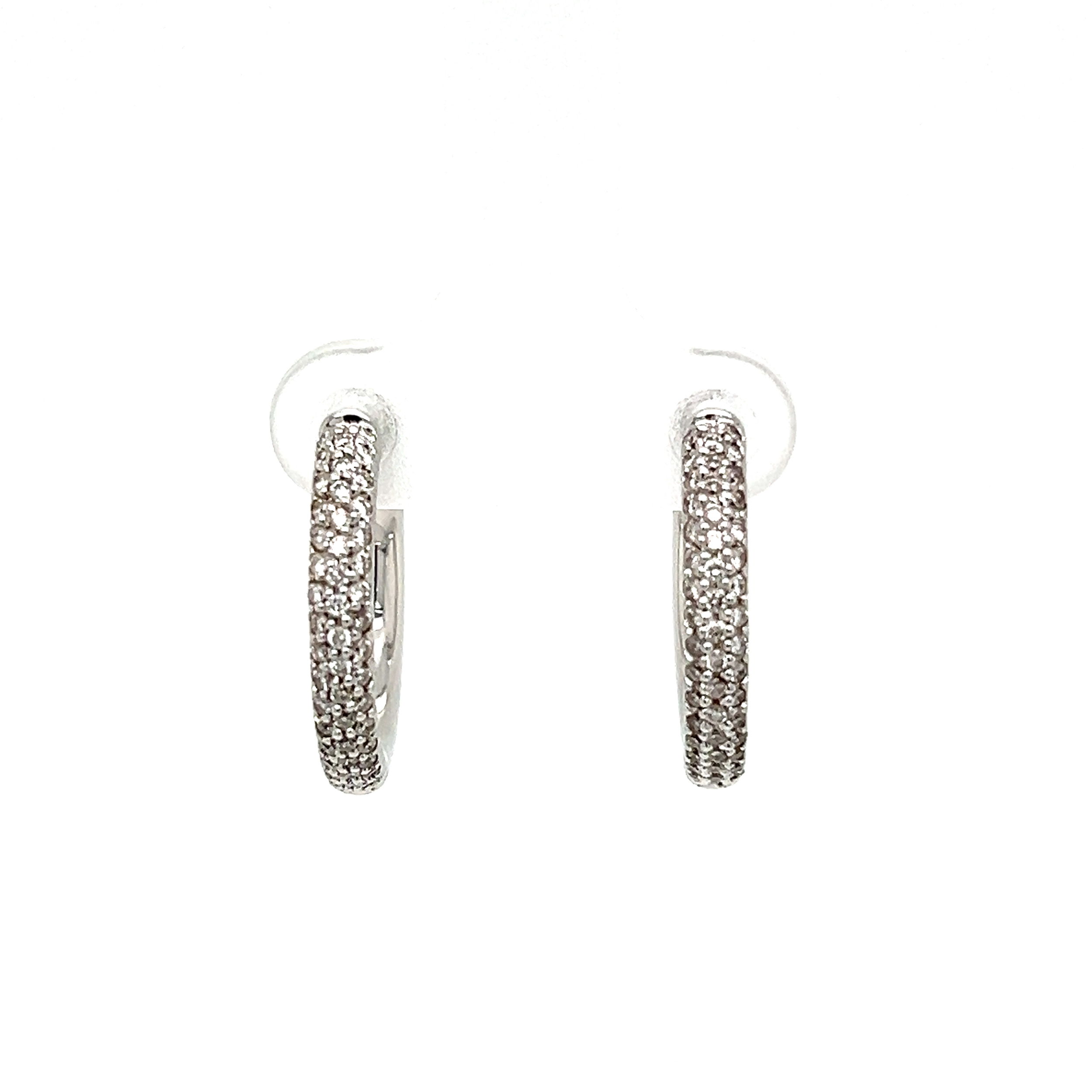 These 18K White Gold 3 Row Pave Diamond Hoop Earrings are a timeless addition to any wardrobe. Expertly crafted with luxury detail, these earrings boast a total weight of 6.0g and boast a dazzling 0.60tcw of glittering diamonds. The hoop measures 20mm in diameter and features a classic pave setting. Perfect for any special occasion, these earrings will add timeless luxury to your look. 18K WG 3 Row Pave .60tcw Diamond Hoop Earrings 6.0g, 20mm