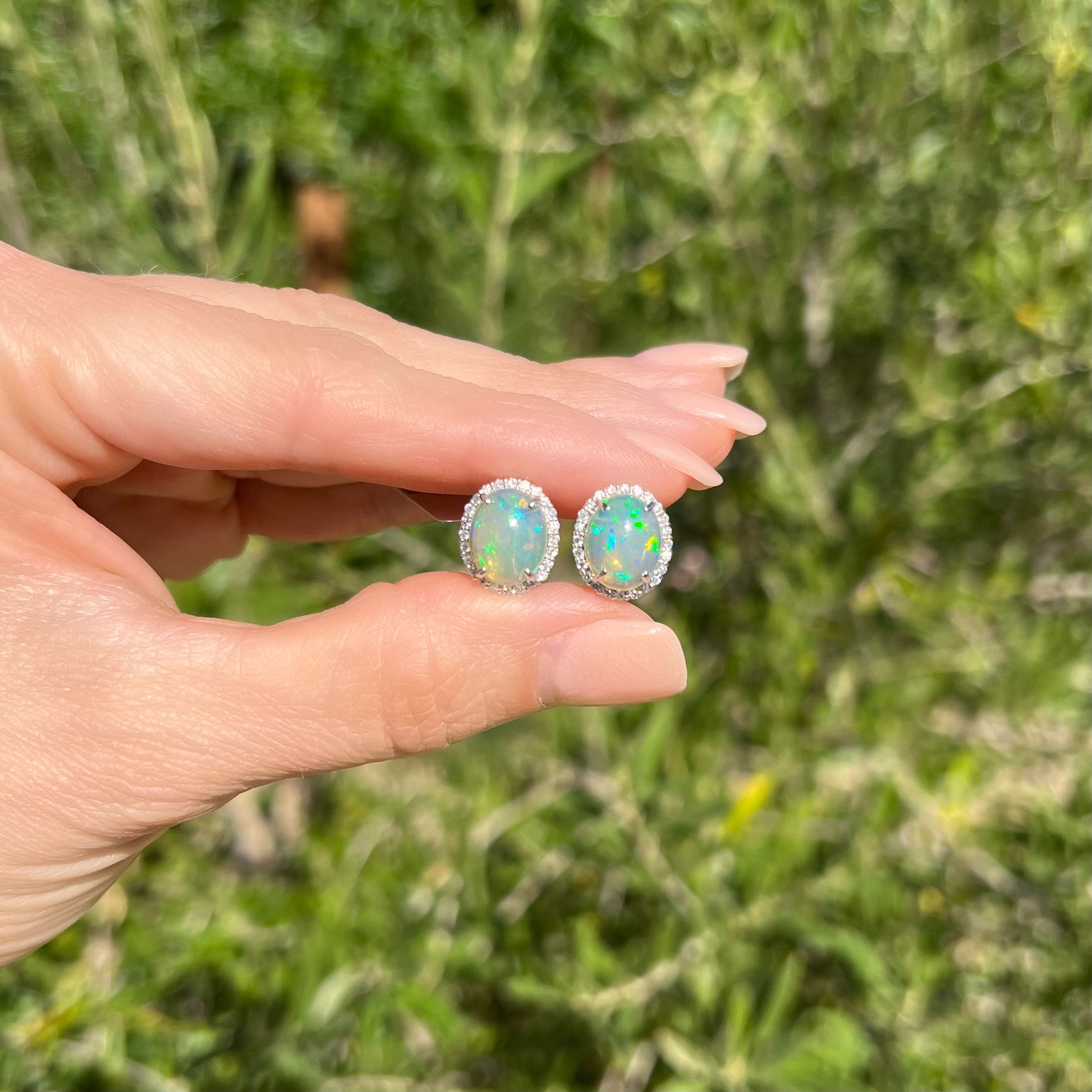 Make a statement with these eye-catching Platinum 900 Crystal 3.44tcw Opal & .38tcw Diamond Halo Clip Earrings. Featuring a captivating round 3.44tcw opal at the center of each earring, these beauties are surrounded by a twinkling .38tcw halo of diamonds that will have you glistening in the light. Crafted of platinum with 6.6g of weight and measuring .6", these estate earrings will add a touch of timeless elegance to any look. Make these gorgeous earrings your favorite new accessory today! Platinum 900 Crystal 3.44tcw Opal & .38tcw Diamond Halo Clip Earrings 6.6g, .6"