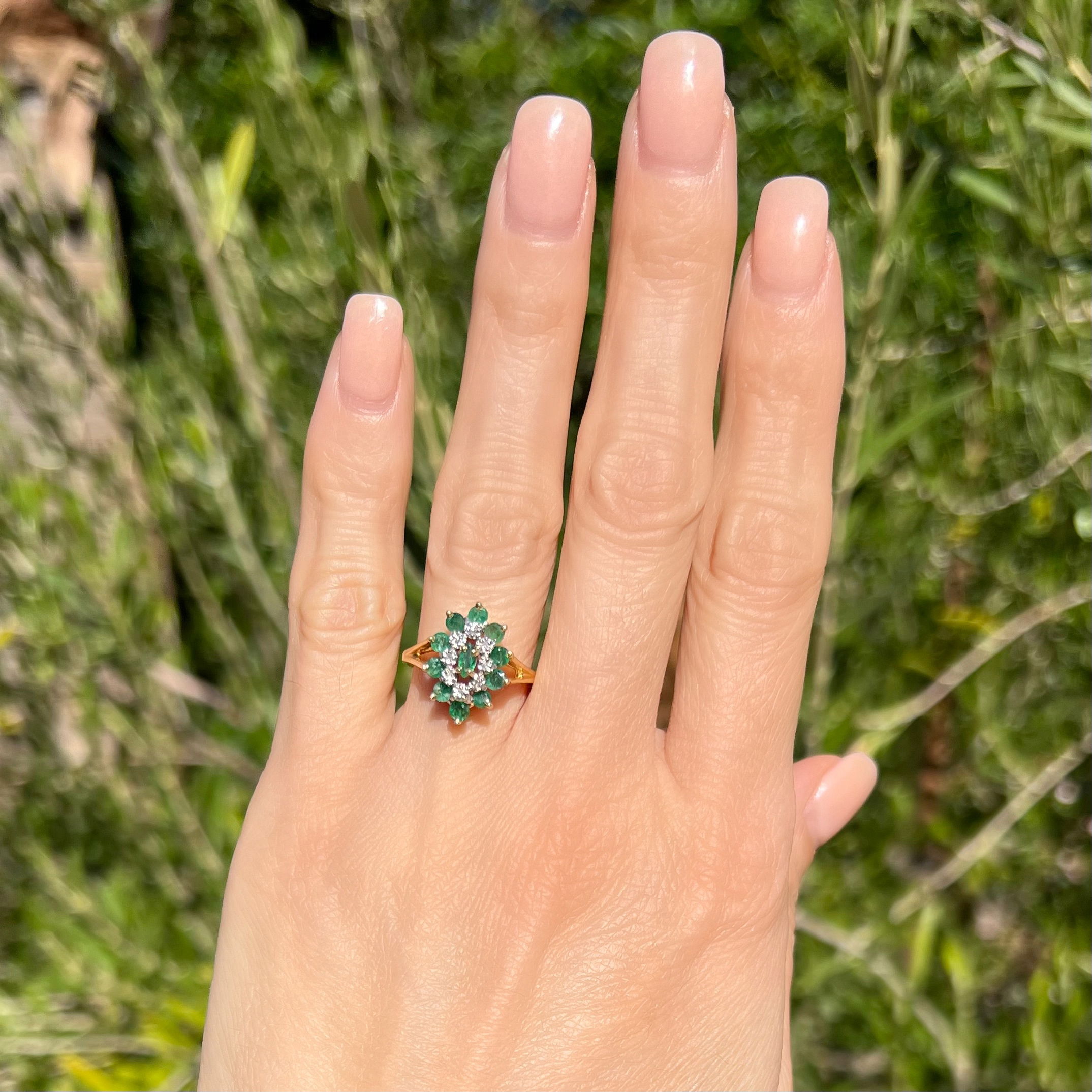 This gorgeous 14K Yellow Gold 1960's vintage ring is crafted in an exquisite marquis-shaped cluster design, featuring breathtaking emerald gemstones and diamond accents. This spectacular piece is adorned with an impressive .70ct of round cut emerald gemstones and .04ct of round cut diamonds making this ring a true marvel. An outstanding 3.8g and size 6.5, this ring radiates in its brilliance of beautiful color and sparkle - it's sure to be treasured for its timeless and classic beauty. 14K YG 1960's .70tcw Emerald & .04tcw Diamond Marquis Shape Cluster Ring 3.8g, s6.5