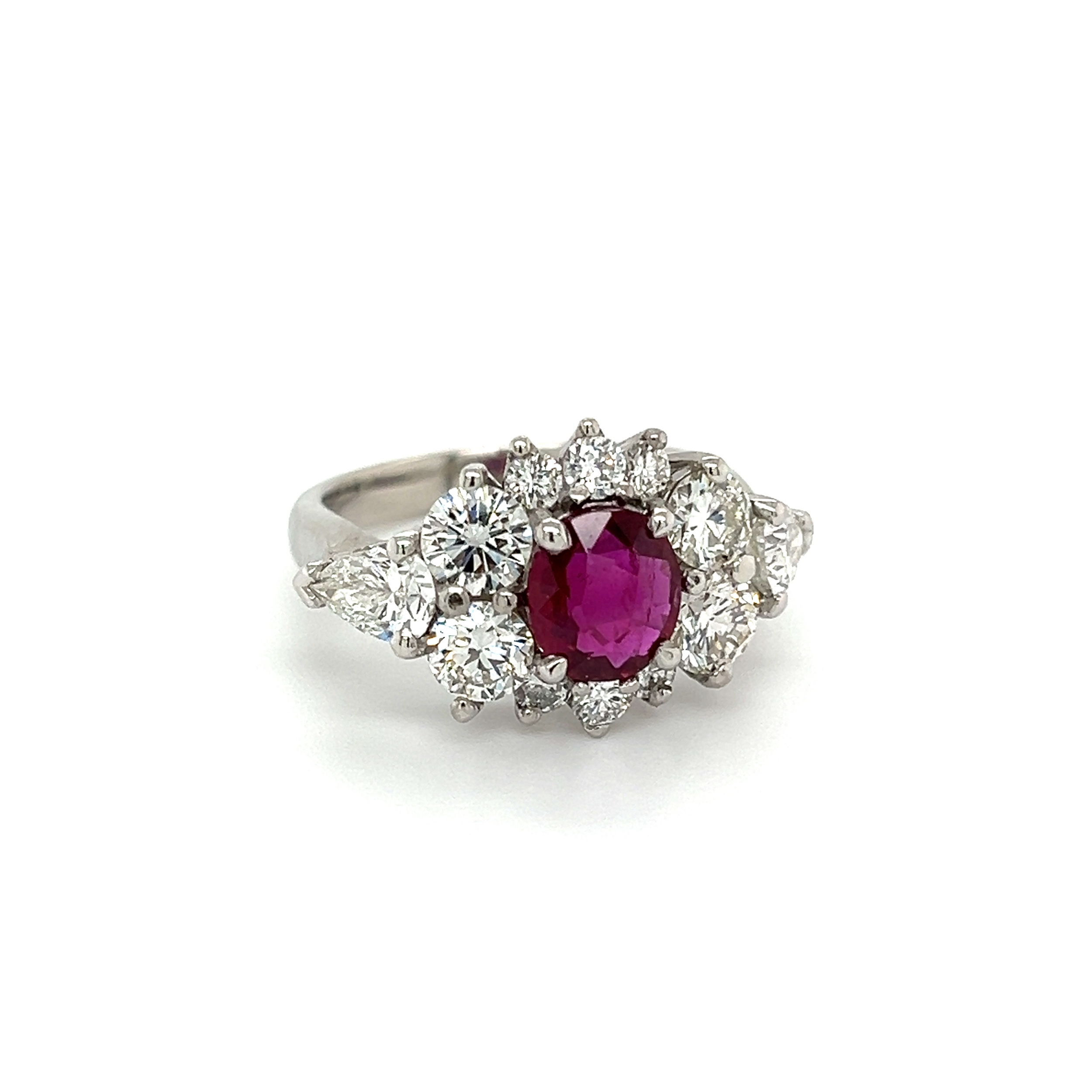 This exquisite estate ring is sure to make a statement! Crafted from 10.8g of solid platinum, this stunning piece of jewelry features a beautiful 1.53ct NO HEAT ruby certified by GIA with report number 5221986529. Accenting the ruby is a halo of 3.00tcw round brilliant cut diamonds and two pear cut diamonds. With a size 7.5, this ring is perfect for any occasion. Let this luxurious ring help you sparkle and shine! Platinum Oval 1.53ct NO HEAT Ruby GIA & 3.00tcw RBC & Pear Diamond Ring 10.8g, s7.5