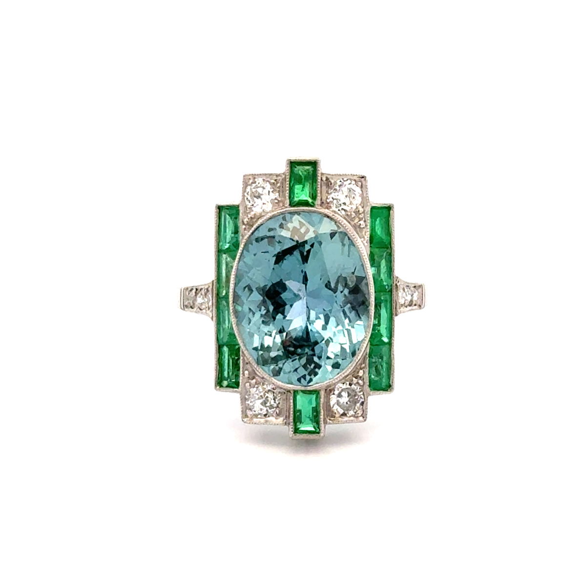 An Art Deco style ring with a light blue center framed by calibre emeralds and old-cut diamonds