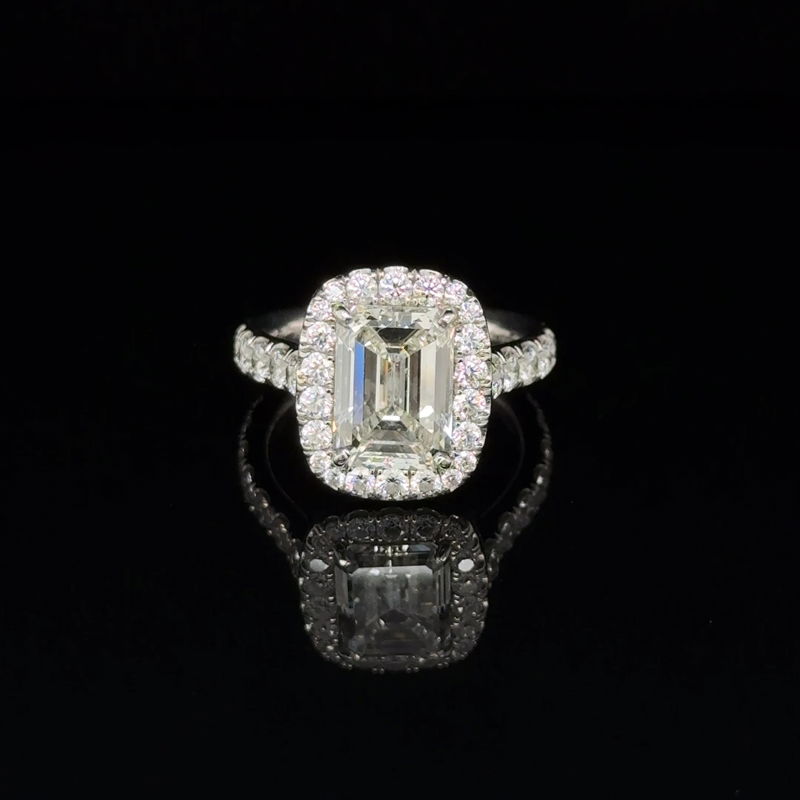 An emerald-cut diamond halo ring
