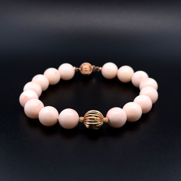 Closeup photo of 14K YG 10mm Round Angel Skin Coral Bead & Gold Bead Bracelet 23.7g, 8"