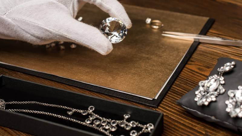 Jewelry appraisal tools arranged beside fine jewelry