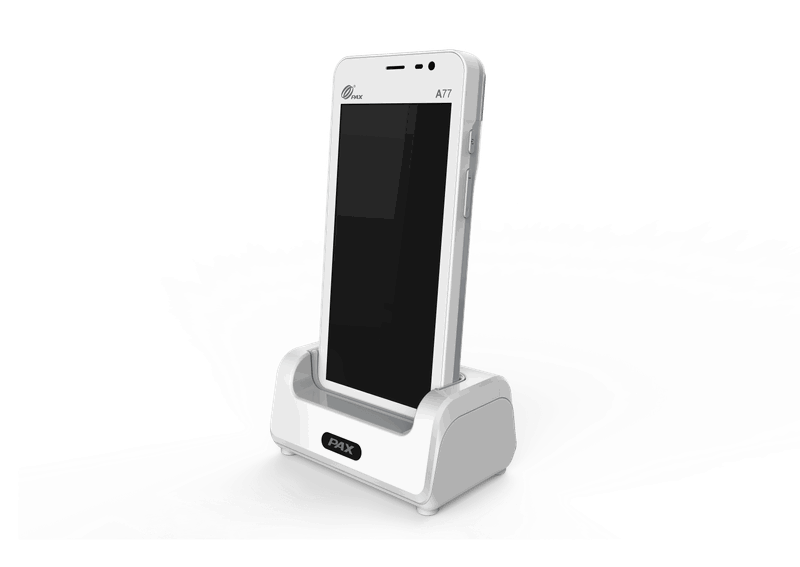 PAX A77 handheld POS terminal with touchscreen seated in a white PAX charging dock