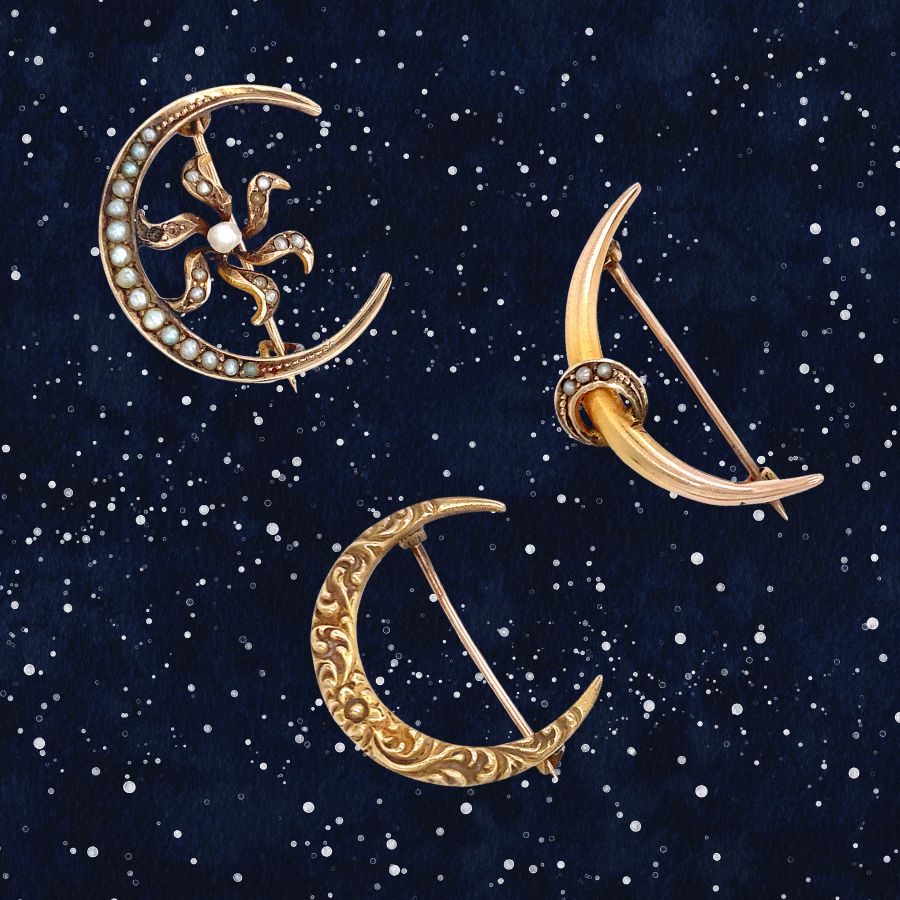 three antique crescent moon pins in gold on starry background
