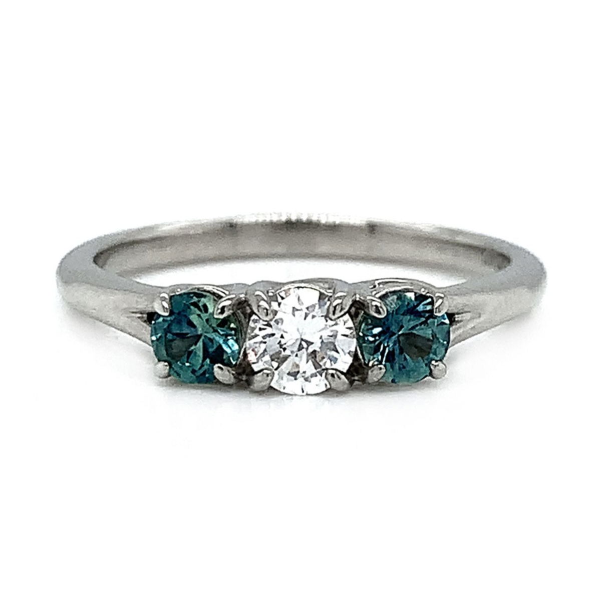 Modern three-stone engagement ring with diamond center and sapphires on each side