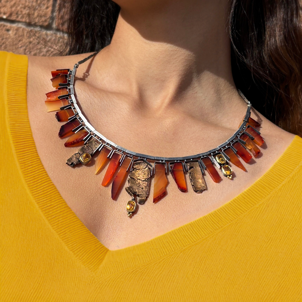 Crew neckline styled with a statement bib necklace to create visual interest.