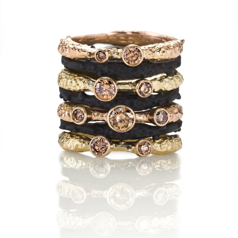 Sarah Graham stacking bands in blackened cobalt chrome yellow gold and cognac diamonds