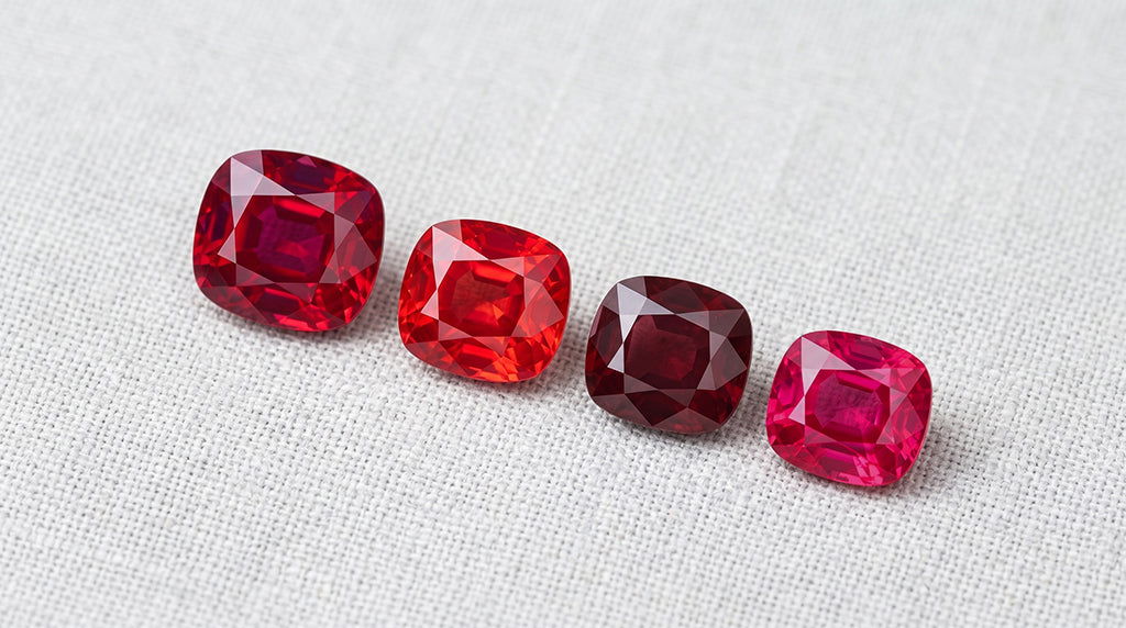 Loose ruby gemstones showing color range from orangy red to purplish red