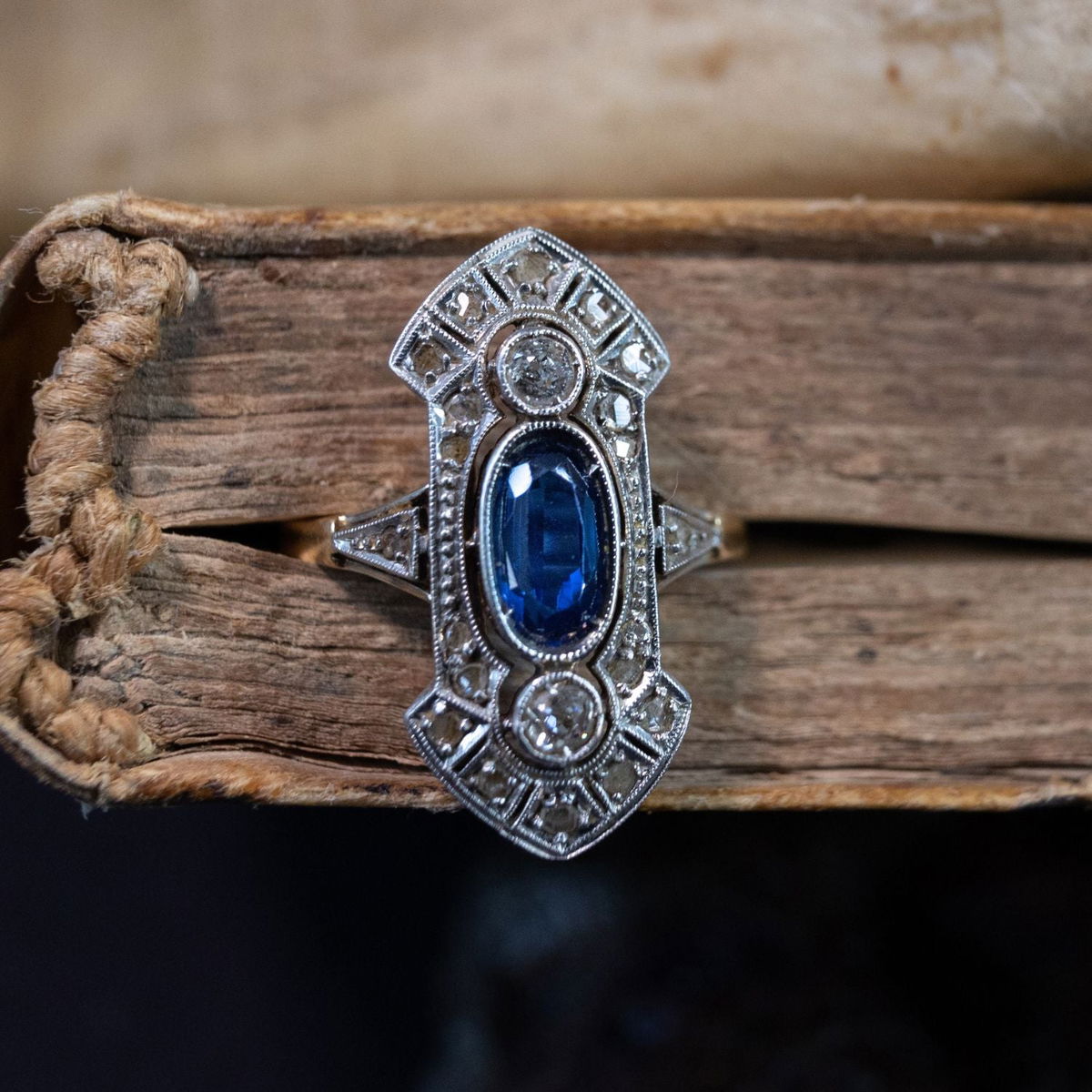 Art Deco era engagement ring featuring geometric navette design with sapphire and diamond