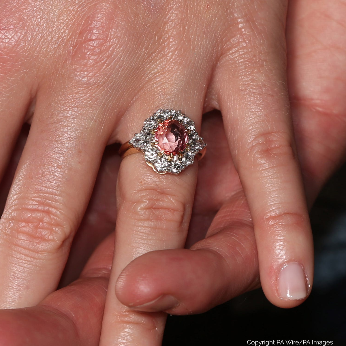 Princess Eugenie’s Padparadscha sapphire engagement ring featuring a peach-pink center stone
