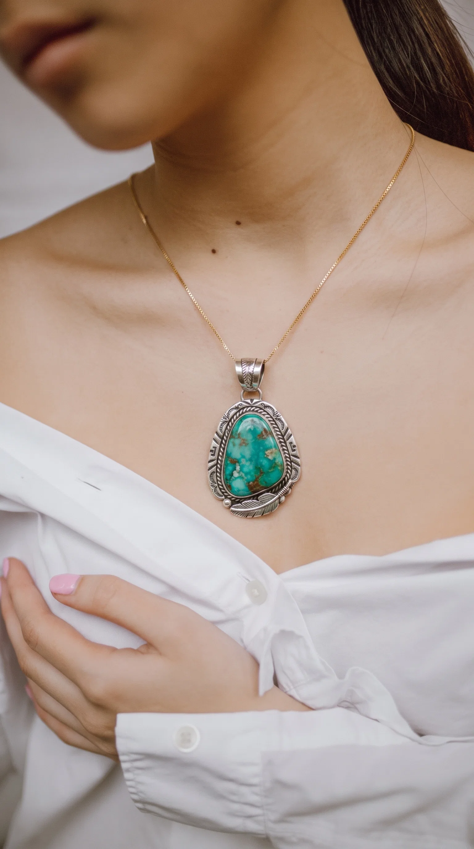 Handcrafted turquoise and sterling silver Native American jewelry arranged on a warm neutral surface