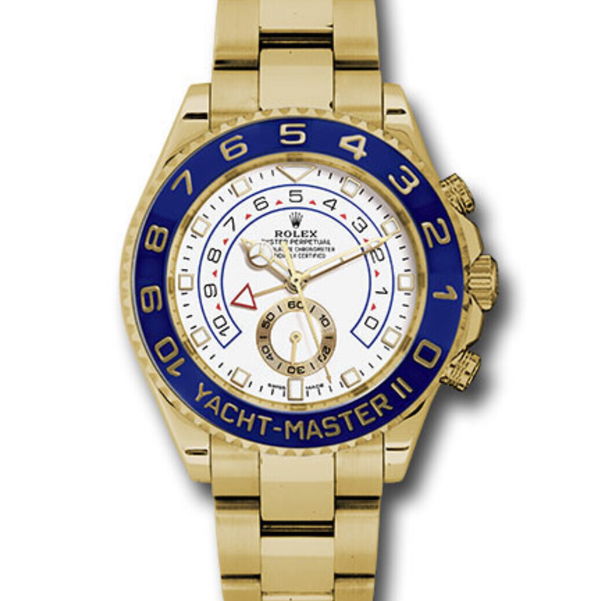 Closeup photo of 44mm 18K yellow gold case, blue ceramic Ring Command bezel, white dial, and Oysterlock bracelet