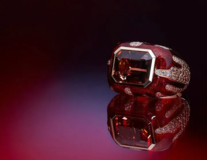Red gemstone cocktail ring on burgundy velvet
