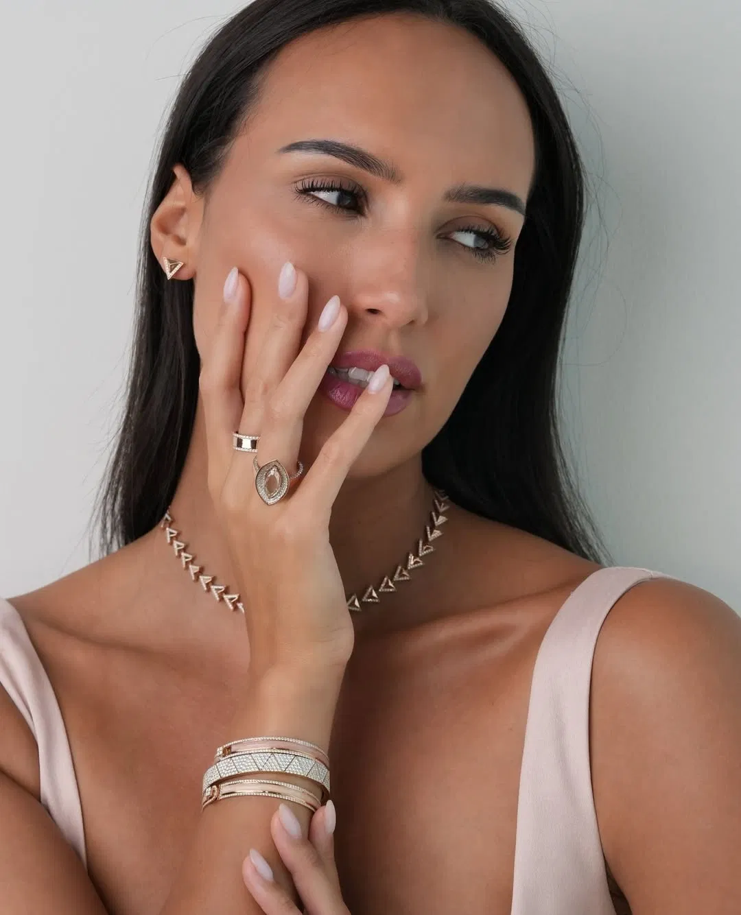 Model wearing a diamond necklace and rings