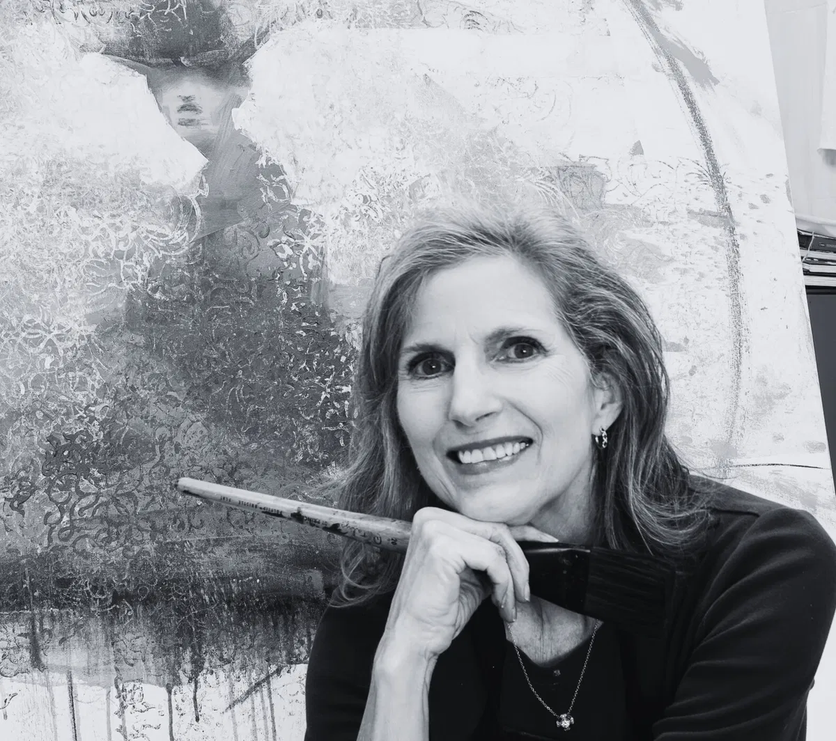Cathy Hegman in her studio with a brush