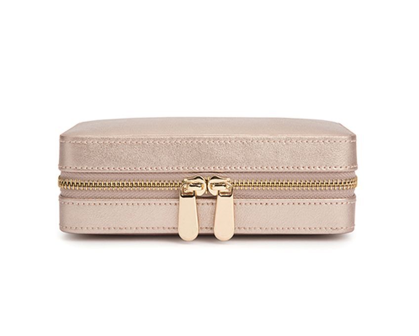 Palermo Zip Jewelry Case in Rose Gold by WOLF 1834 - Charming and sophisticated, Palermo takes cues from its namesake city on the side of a mountain by the sea. Store your favorite pieces in this sumptuous leather zip case while traveling. Includes LusterLoc anti-tarnish lining and gold finish. The case measures 6.75" L X 4.5" W X 2.5" H. Storage: 4 ring rolls, 1 earring tab, 4 necklace hooks, 3 storage compartments, under lid storage, mirror LusterLoc: Allows the fabric lining the inside of your jewelry cases to absorb the hostile gases known to cause tarnishing. Under typical storage conditions, it can prevent tarnishing for up to 35 years. Palermo Zip Jewelry Case in Rose Gold