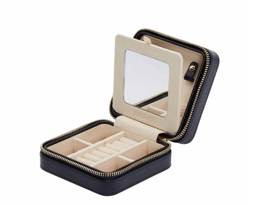 The Maria Small Square Zip Jewelry Case in Navy Blue by WOLF 1834 - A new classic is born with Maria. Pure sophistication with clean lines and just the right amount of detail. Maria is for the traveler in love with cities they’ve never been to, and people they’ve never met. Our first complete travel collection wrapped in rich smooth leathers and stunning gold accents. Take Maria wherever you go while keeping your jewelry in place and creating a travel style that’s just for you - business, leisure, and everything in between. This case is made in luxurious leather and measures 4.5" L X 4.5" W X 2.25" H - Storage: 7 ring rolls, 4 open compartments, 3 necklace snap-on hooks with pocket, 1 ring bar, one earring bar, mirror LusterLoc: Allows the fabric lining the inside of your jewellery cases to absorb the hostile gases known to cause tarnishing. Under typical storage conditions, it can prevent tarnishing for up to 35 years. Maria Small Square Zip Jewelry Case in Navy Blue