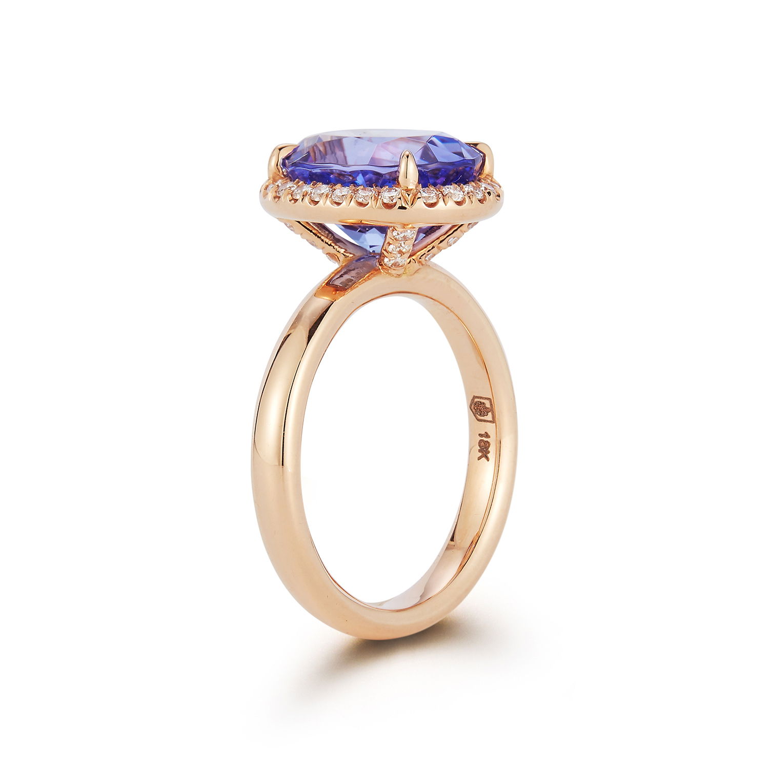 Cocktail Ring with Oval Tanzanite and White Diamonds in 18kt Rose Gold by Katherine Jetter. One oval tanzanite at 5.03ct surrounded by white diamonds at 0.40ctw and set in 18kt rose gold. This ring is a size 6.5. Cocktail Ring with Oval Tanzanite and White Diamonds in 18kt Rose Gold