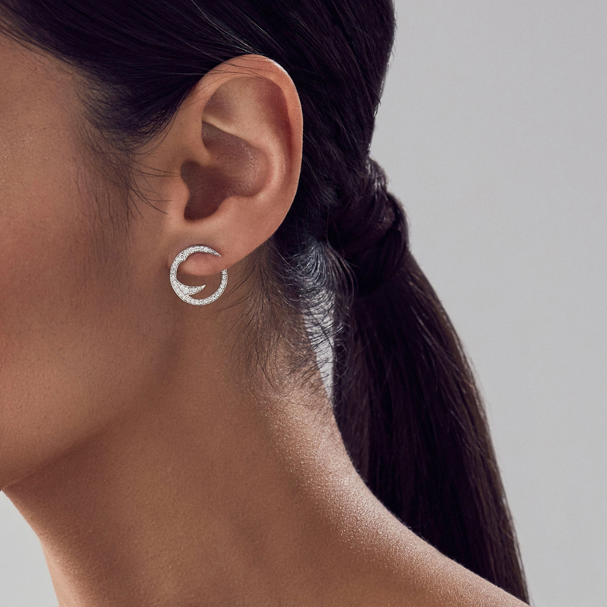 Thorn Stem Mini Hoop Earrings with White Diamonds in 18kt White Gold by Stephen Webster. Wrap around mini hoop earrings in 18kt white gold with white diamond pave at 0.53ctw. Thorn Stem Mini Hoop Earrings with White Diamonds in 18kt White Gold