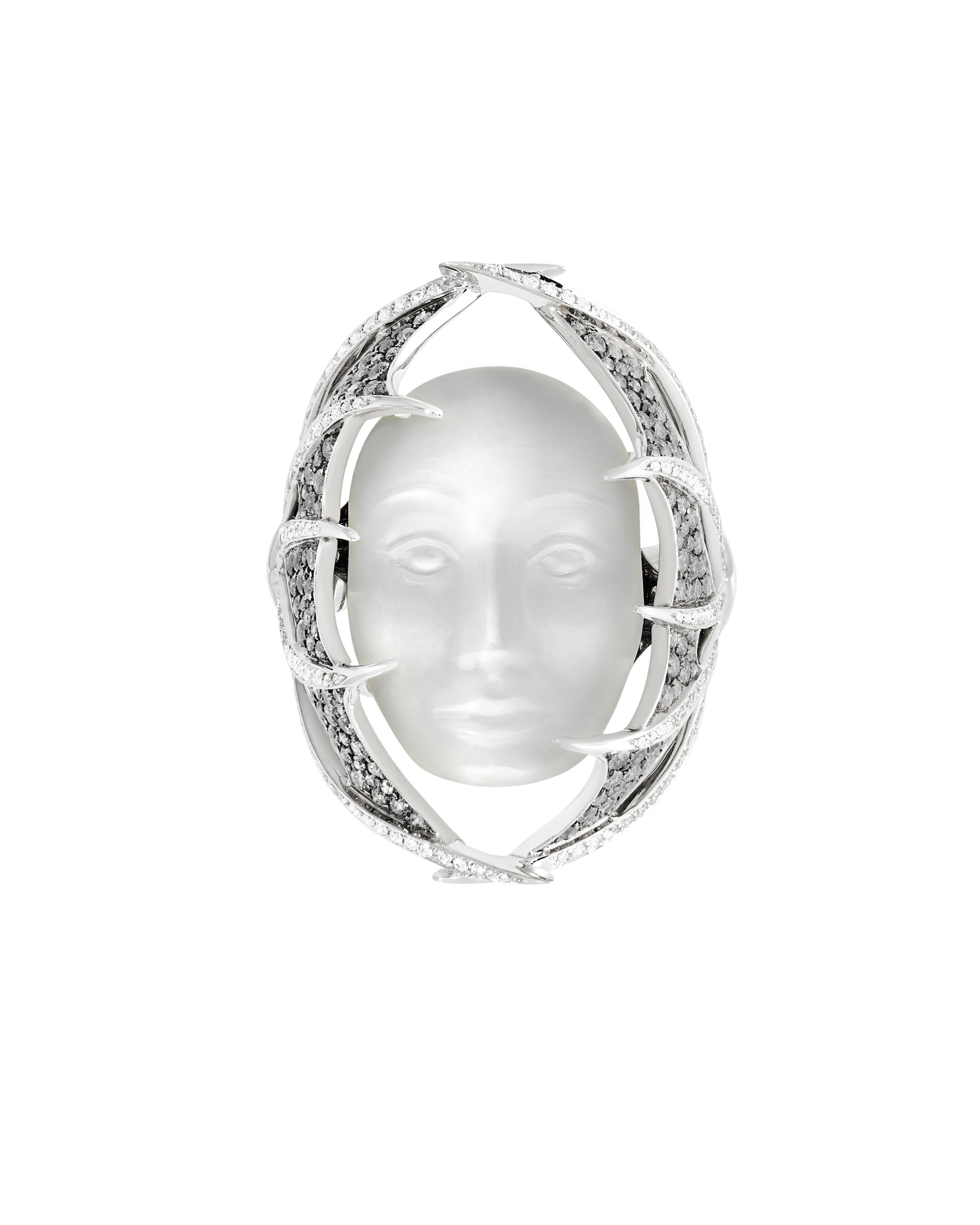 The Rebelles Making Waves Ring with Moonstone Face in 18kt White Gold - Size 7 by Stephen Webster. The ReBelles - Making Waves - 18kt white gold, ring set with white diamond pave 0.65ctw, grey diamond pave 0.98ctw and a carved white Moonstone face 15.50cts. Number 9/10. Inspired by the activist Rachel Carson, a marine biologist who was the first to question the extensive use of synthetic pesticides and the damage they caused to the health of people and the environment. Set in 18kt White Gold, featuring a central carved Moonstone face with Grey and White Diamond spines. Limited production of 10 per design. Each piece is numbered and engraved with MAKING WAVES. The Rebelles Making Waves Ring with Moonstone Face in 18kt White Gold - Size 7