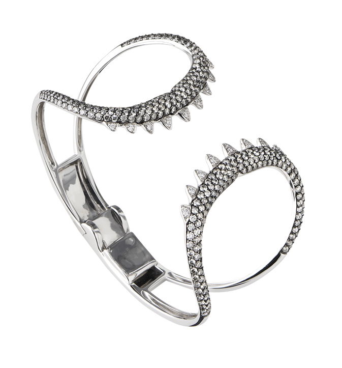 No Regrets Jewels Verne Shark Jaw Bracelet with Silver and White Diamonds in 18kt White Gold - 6.75" Long by Stephen Webster. Wide hinged cuff bracelet in 18kt white gold with black rhodium over and shark teeth motif accented with 4.32ctw of silver diamond pave and 0.28ctw of white diamond pave. No Regrets Jewels Verne Shark Jaw Bracelet with Silver and White Diamonds in 18kt White Gold - 6.75" Long
