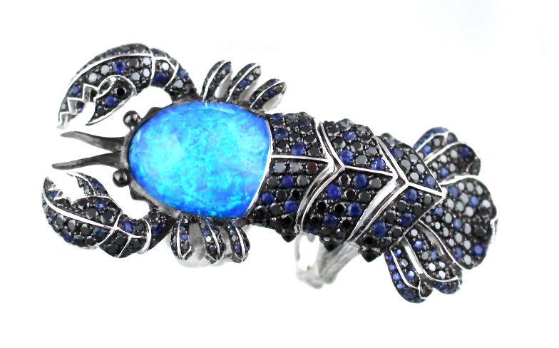 No Regrets Jewels Verne Lobster CH2 Ring with Black Opalescent and Black Diamonds in 18kt White Gold - Size 6 by Stephen Webster. Statement cocktail ring in 18kt white gold, black rhodium plating, black opalescent with clear quartz Crystal Haze 20.16ct, blue sapphire pave 2.26ct, black diamond pave 3.86ct and onyx 0.45ct. No Regrets Jewels Verne Lobster CH2 Ring with Black Opalescent and Black Diamonds in 18kt White Gold - Size 6