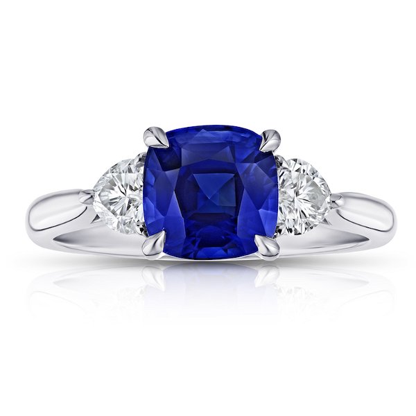 Closeup photo of 2.61 carat cushion blue sapphire with heart shape diamonds .49 carats set in a platinum ring