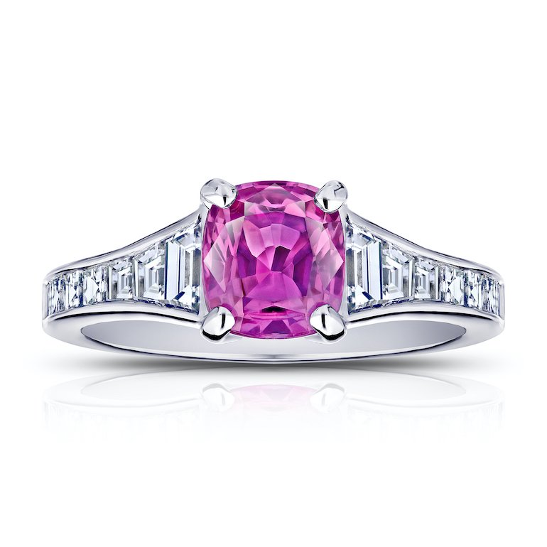 1.38 carat cushion pink sapphire with 14 trapezoid and carre diamonds .84 carats channel set in a platinum ring