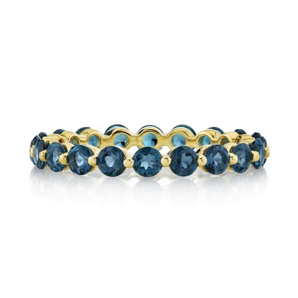 Closeup photo of Eternity Stacking Band Ring 2.8mm with London Blue Topaz and Prong Spacers in 18kt Yellow Gold