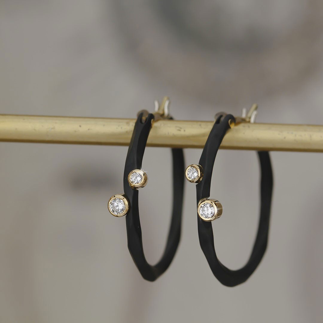 Rogue River Extra Small Hoop Earrings with White Diamonds in 18kt White Gold and Black Chrome by Sarah Graham. The extra small hoop earrings measure 1 inch in diameter and are created in blackened cobalt chrome with four white diamonds at 0.16ctw set into 18kt yellow gold. Rogue River Extra Small Hoop Earrings with White Diamonds in 18kt Yellow Gold and Black Chrome
