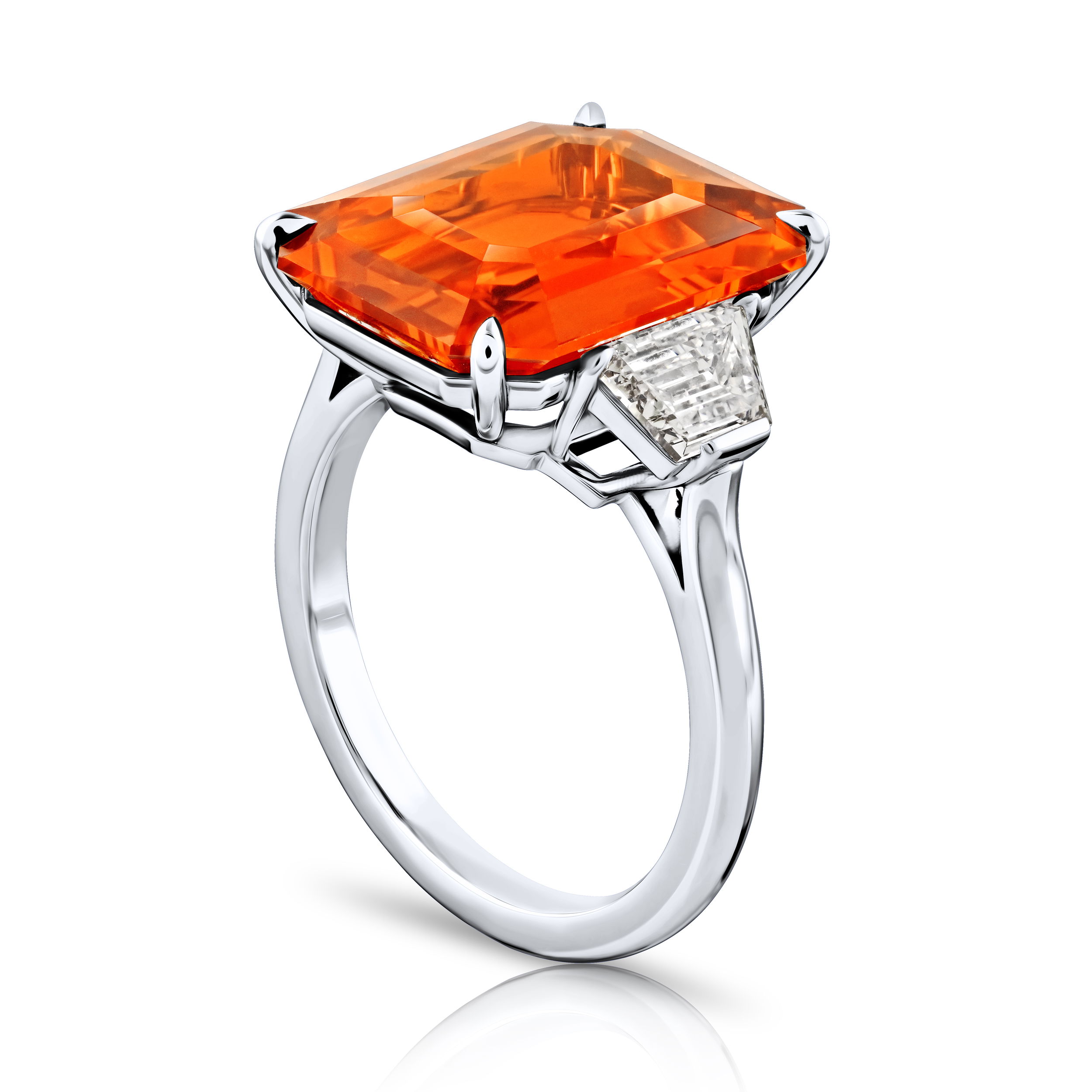 10.53ct Emerald Cut Orange Sapphire with two trapezoid step cut diamonds at 1.02ctw set in a handmade platinum ring.