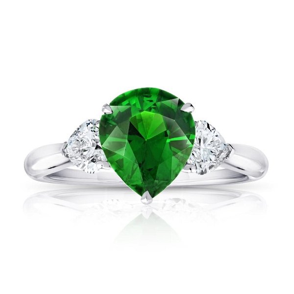 Closeup photo of 2.07ct Pear green tsavorite with two heart diamonds at 0.60ctw set in a handmade platinum ring