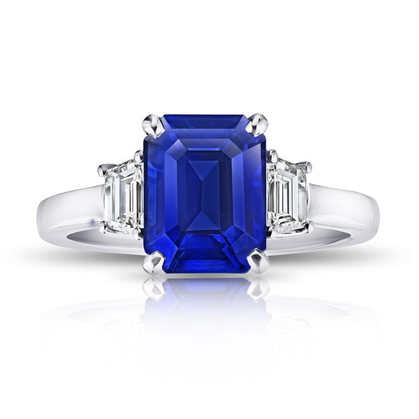 Closeup photo of 4.01ct emerald cut blue sapphire with trapezoid diamonds at 0.57ctw set in a platinum ring