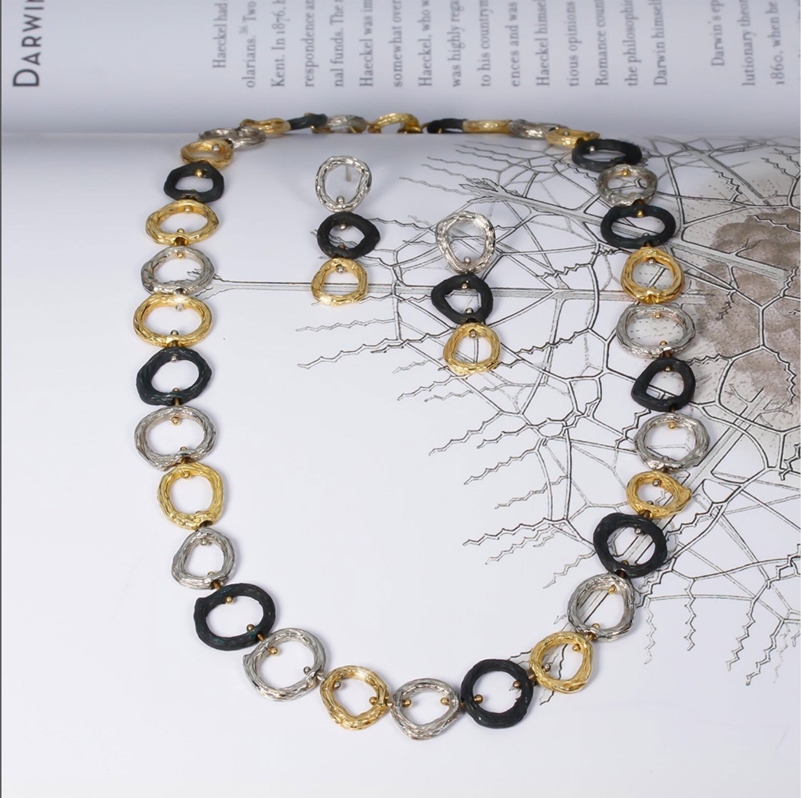 Pebble Tri-Color Link Necklace in 18kt Yellow Gold, White Gold and Black Chrome by Sarah Graham. Alternating links of yellow gold, white gold and oxidized cobalt chrome.? The necklace measures 18 inches long with a toggle clasp. Pebble Tri-Color Link Necklace in 18kt Yellow Gold, White Gold and Black Chrome