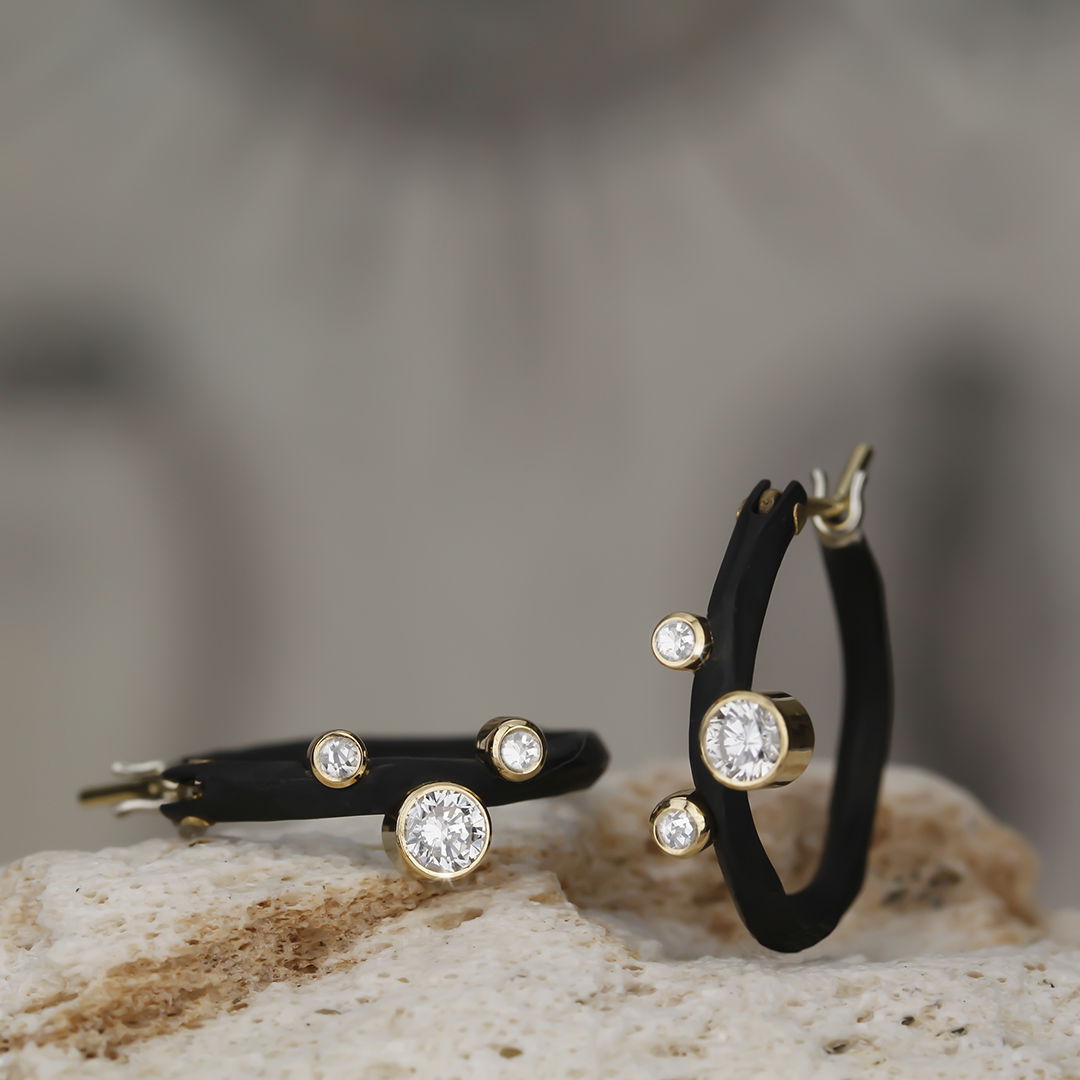 Rogue River Small Hoop Earrings with 6 White Diamonds in 18kt White Gold and Black Chrome by Sarah Graham. The small hoops in blackened cobalt chrome are accented with six white diamonds at 0.20ctw set in 18kt yellow gold. Rogue River Small Hoop Earrings with 6 White Diamonds in 18kt Yellow Gold and Black Chrome
