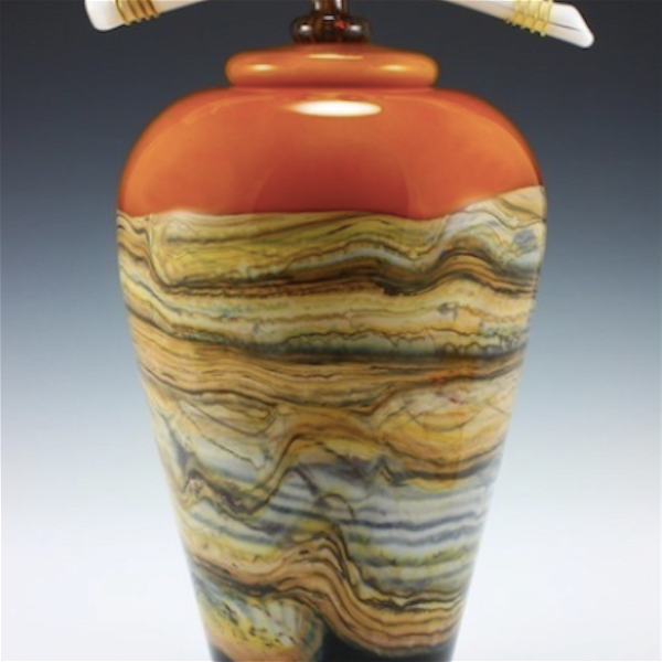 Closeup photo of Strata Small Covered Jar in Tangerine Glass with Bone and Tendril Finial