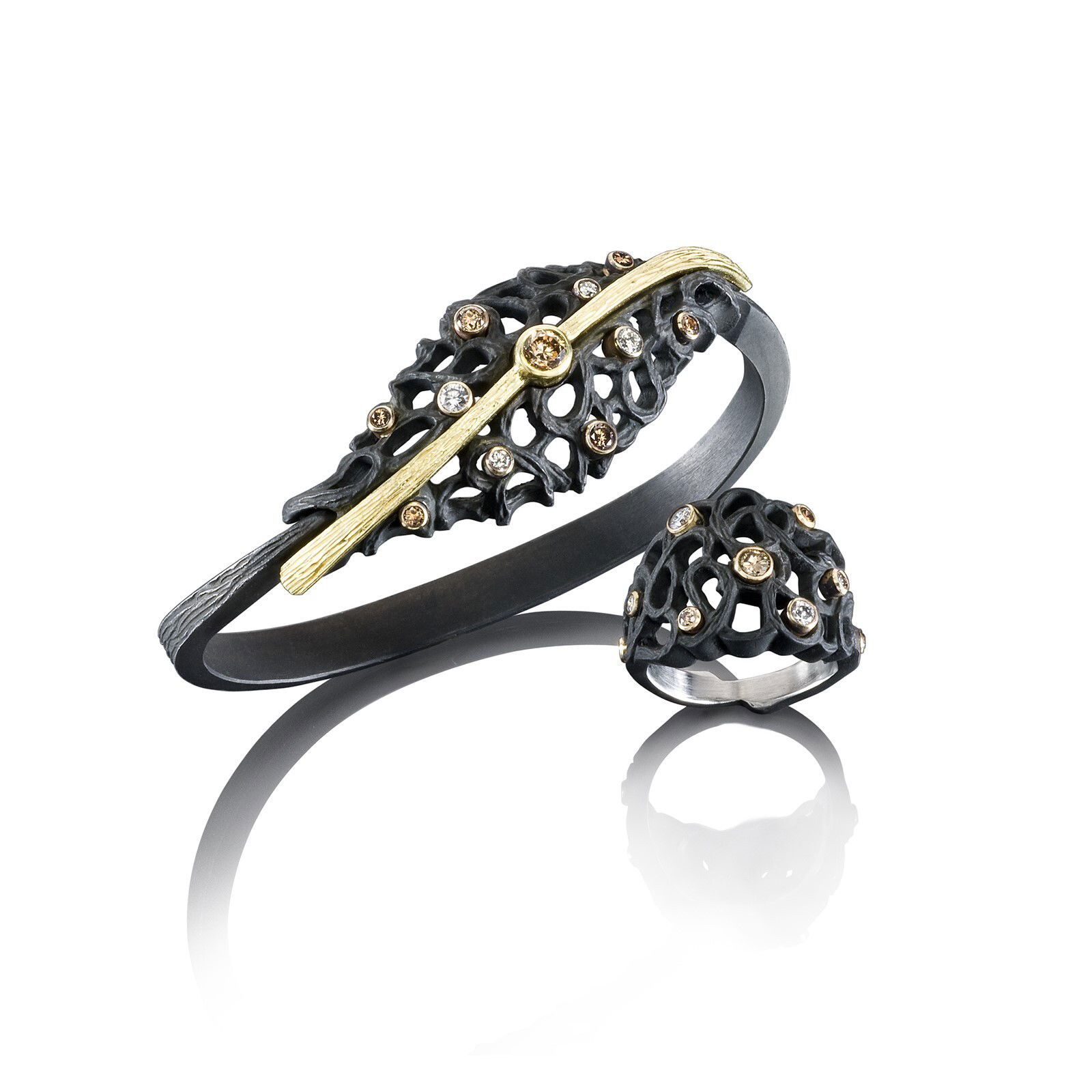 Shadow Dome Cuff Bracelet with White and Cognac Diamonds in Black Chrome and 18kt Yellow Gold by Sarah Graham. Shadow dome in oxidized cobalt chrome at the top of the cuff, accented with 0.88ctw of white and cognac diamonds and set with a center cognac diamond of 0.50ct. The back of the bracelet shank is 18kt yellow gold. Shadow Dome Cuff Bracelet with White and Cognac Diamonds in Black Chrome and 18kt Yellow Gold