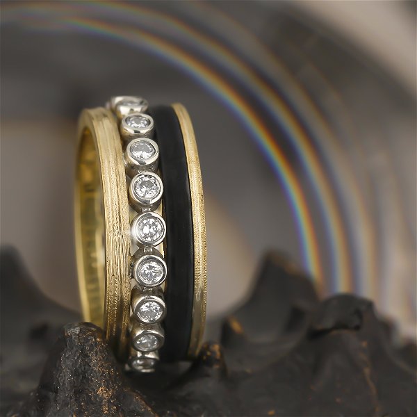 Closeup photo of Paramount Quad Band Ring with White Diamonds in Black Chrome and 18kt Yellow and White Gold