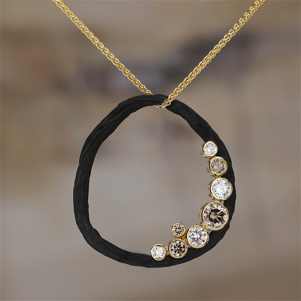 Closeup photo of Pebble Medium Circle Diamond Necklace with White and Cognac Diamonds in Black Chrome and 18kt Yellow Gold
