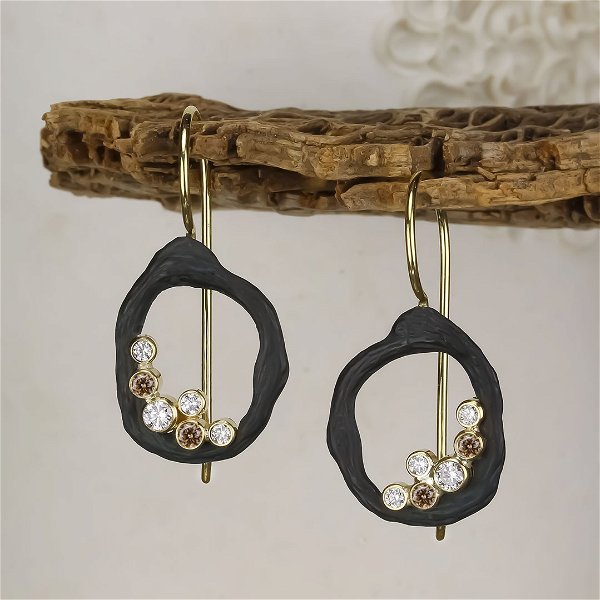 Closeup photo of Pebble Single Link Earrings on Wires with White and Cognac Diamonds in 18kt Yellow Gold and Black Chrome
