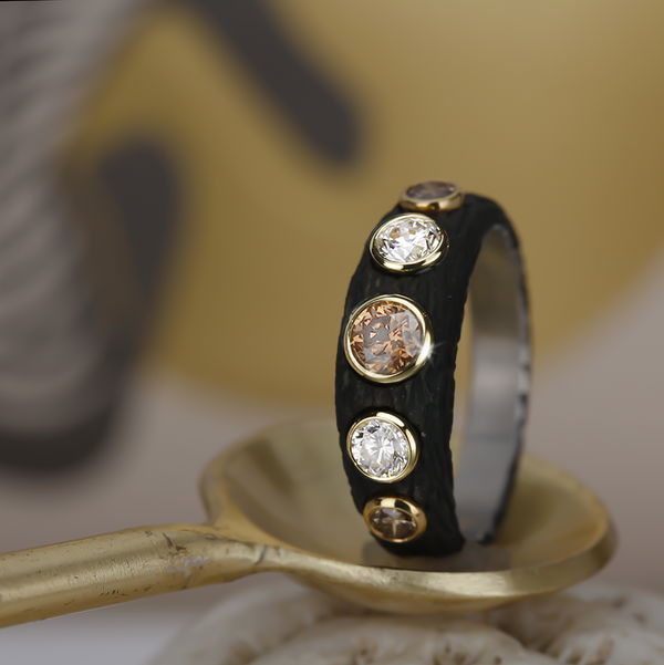 Closeup photo of Pebble Bold Tapered Band Ring with White and Cognac Diamonds in Black Chrome and 18kt Yellow Gold